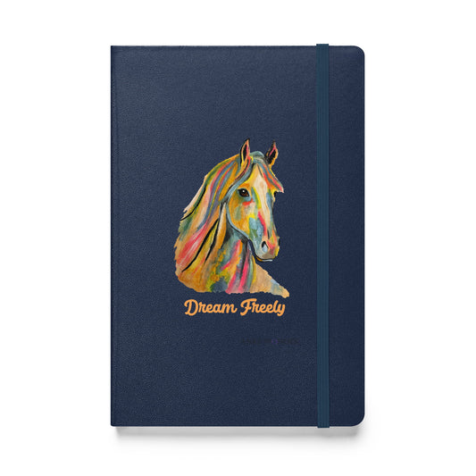 A navy blue hardcover notebook with an elastic closure band, featuring a colorful painted horse head illustration and the words 'Dream Freely' in gold on the front cover, shown against a plain white background.