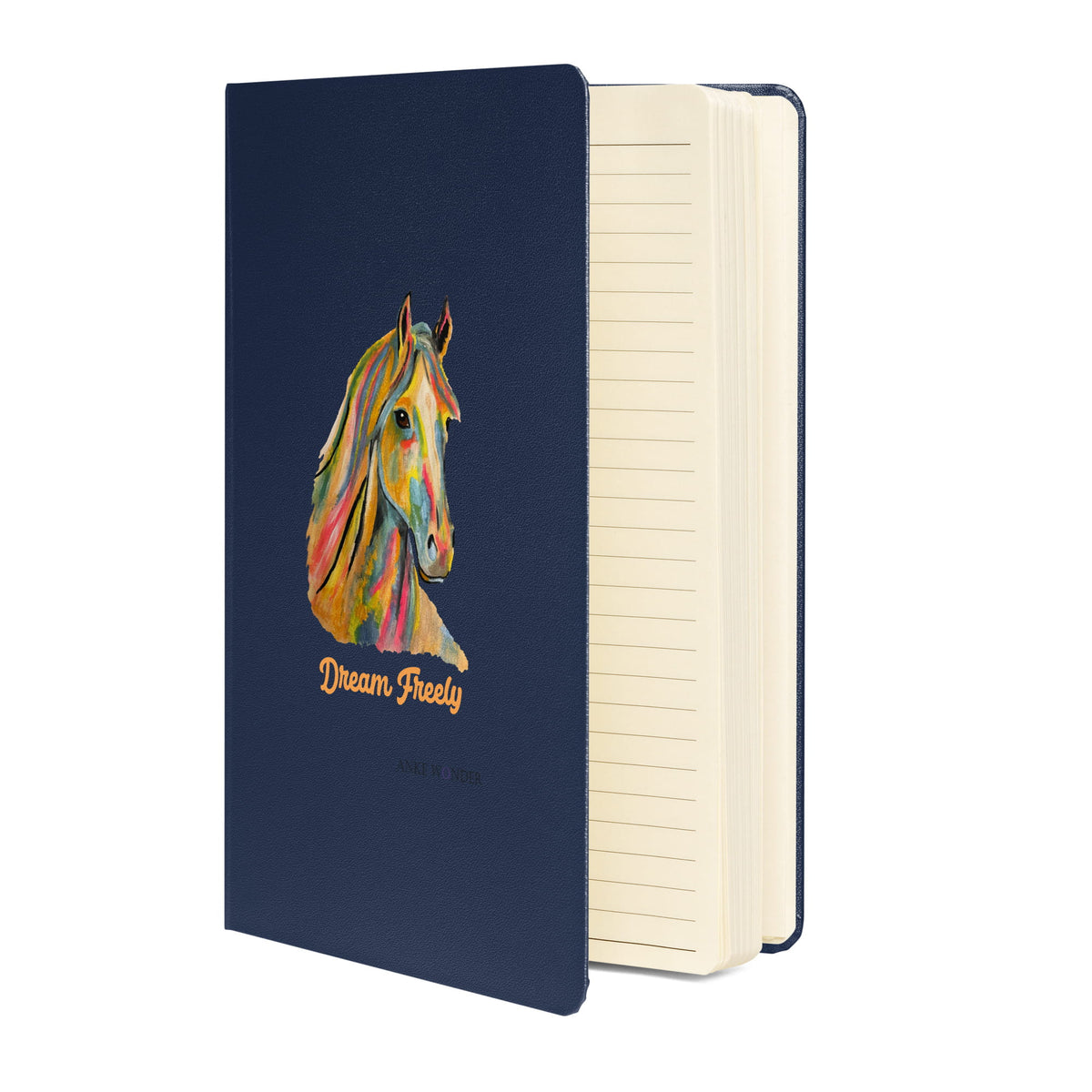 A navy blue hardcover notebook with a colorful painted horse illustration and the words 'Dream Freely' on the front cover, shown standing open to reveal cream-colored lined pages.