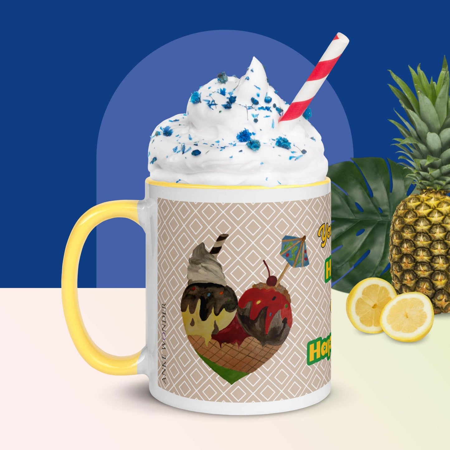 Left side of a ceramic mug with a yellow handle, showcasing a hand-drawn heart made of colorful ice cream scoops.The mug is filled with white cream and lue sprinkles. In the background is a pineapple and lemon.