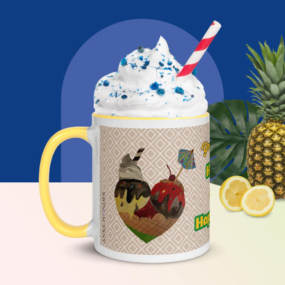 Left side of a ceramic mug with a yellow handle, showcasing a hand-drawn heart made of colorful ice cream scoops.The mug is filled with white cream and lue sprinkles. In the background is a pineapple and lemon.