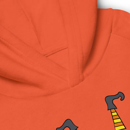 Close-up of an orange hoodie with cartoonish witch hat design on a white background