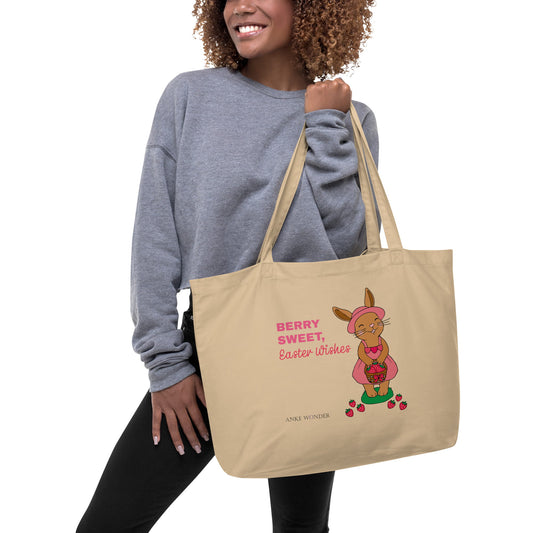 Woman holding a beige tote bag with Easter design and text 'Berry Sweet Easter Wishes'