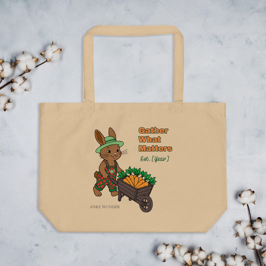 Beige tote bag with a cartoon rabbit and 'Gather what matters Est. Year' on a light gray background with cotton branches.
