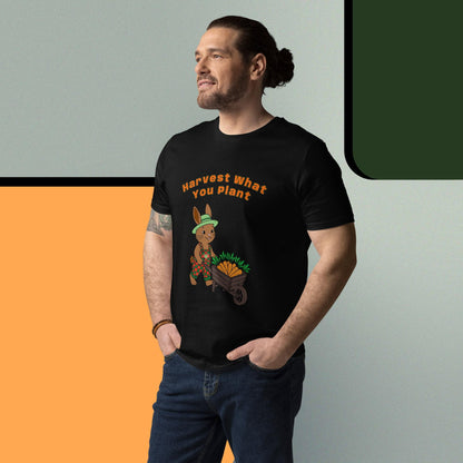 Man wearing a black t-shirtgraphic of a rabbit and text 'Harvest What You Plant', standing against a gradient background.