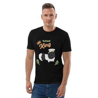 Man wearing an organic cotton t-shirt in black with a "Salad King" design featuring a black and white guinea pig in a chef’s hat, surrounded by greens.