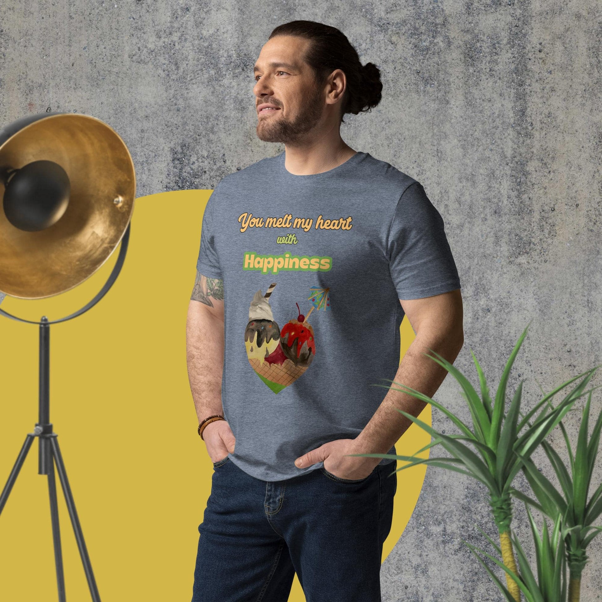 Side-angled view of man wearing a dark heather blue organic cotton t-shirt with illustrated ice cream cone heart and uplifting quote, showcasing fit and print placement.