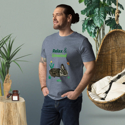 Man wearing dark heather grey organic cotton t-shirt with hand-painted black-and-white rabbit, greens, butterfly, and "Relax & Unwind" text — front view, right angle.