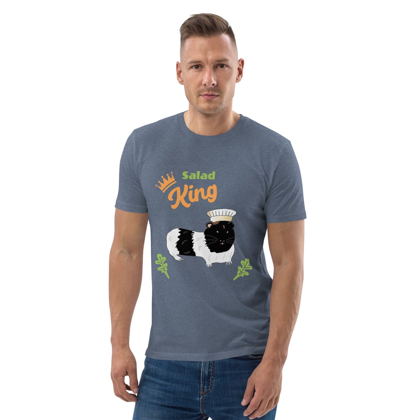 Man wearing an organic cotton t-shirt in heather blue with a "Salad King" design featuring a black and white guinea pig in a chef’s hat, surrounded by greens.