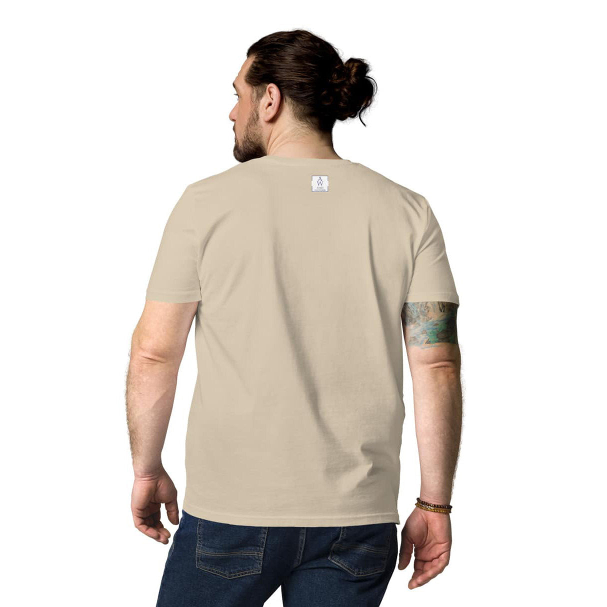 Back view of man wearing plain desert dust organic cotton t-shirt showing clean and minimal back with the Anke Wonder logo.