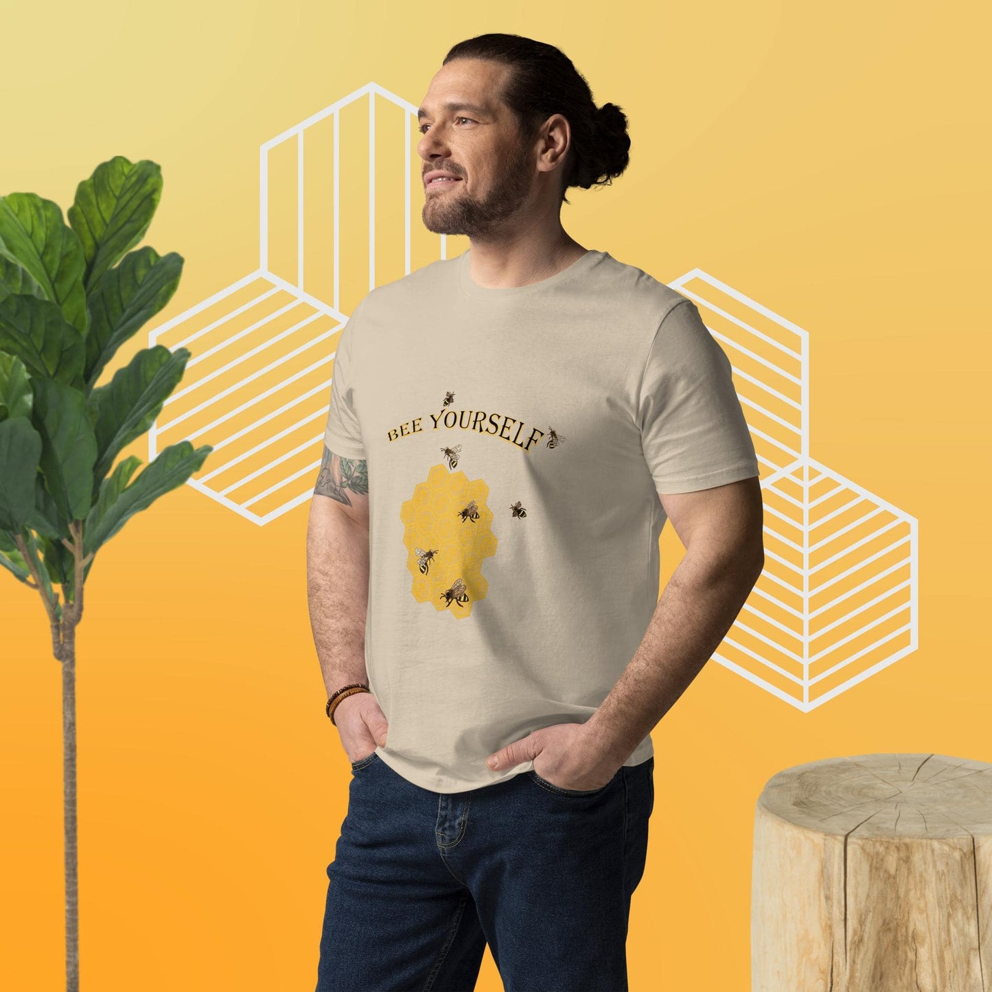 Man wearing a t-shirt with a bee-themed design  of a beecomb and the words 'Bee Yourself' on a yellow background
