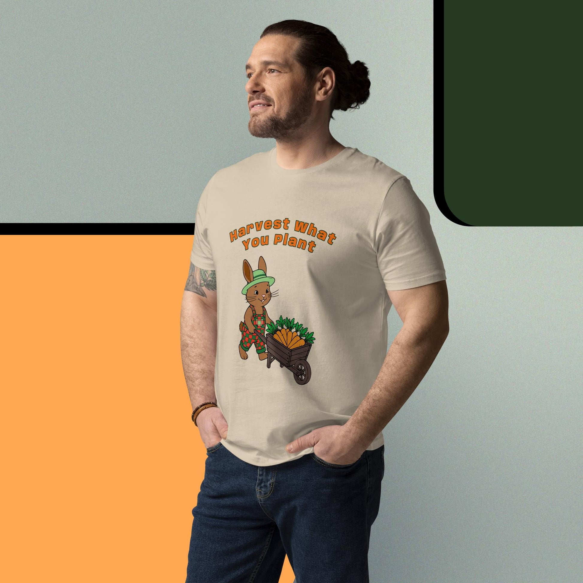 Man wearing a t-shirt with graphic of a rabbit and text 'Harvest What You Plant', standing against a gradient background.
