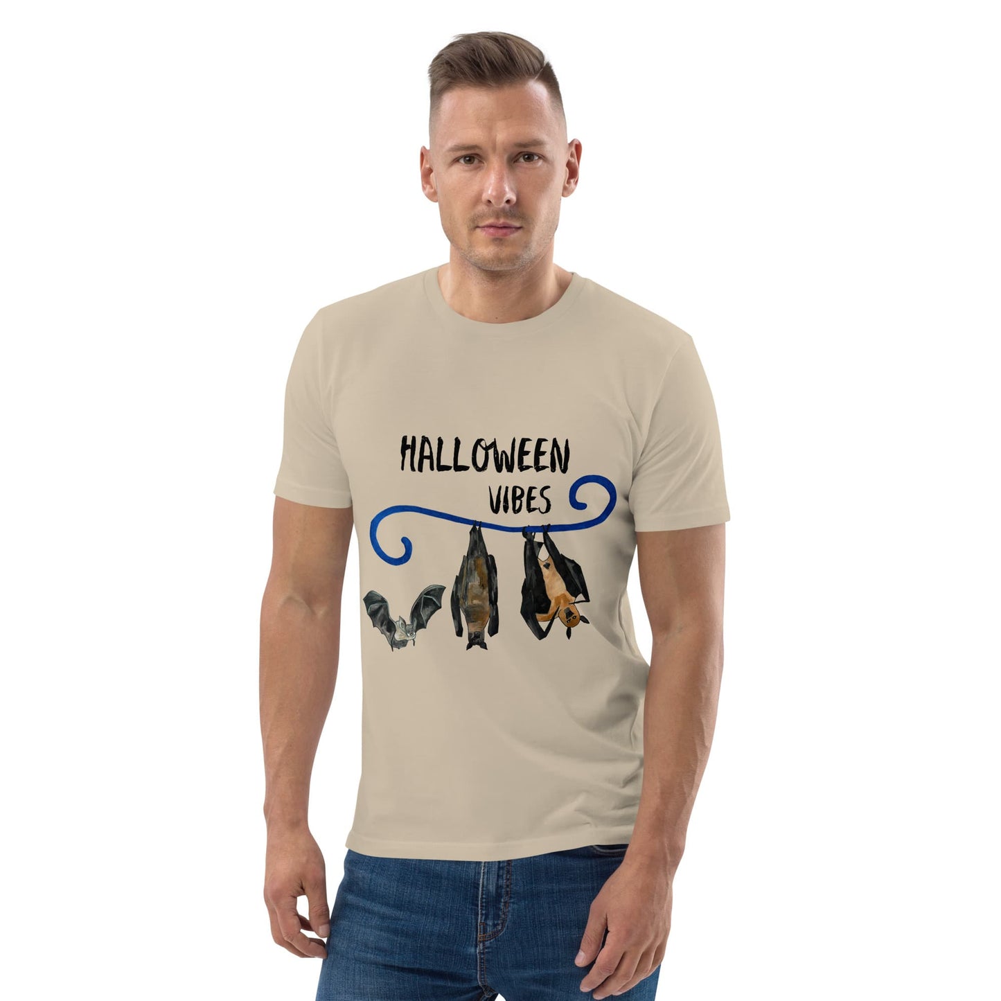 Man wearing a beige t-shirt with 'Halloween Vibes' design featuring bats and bats on a white background.