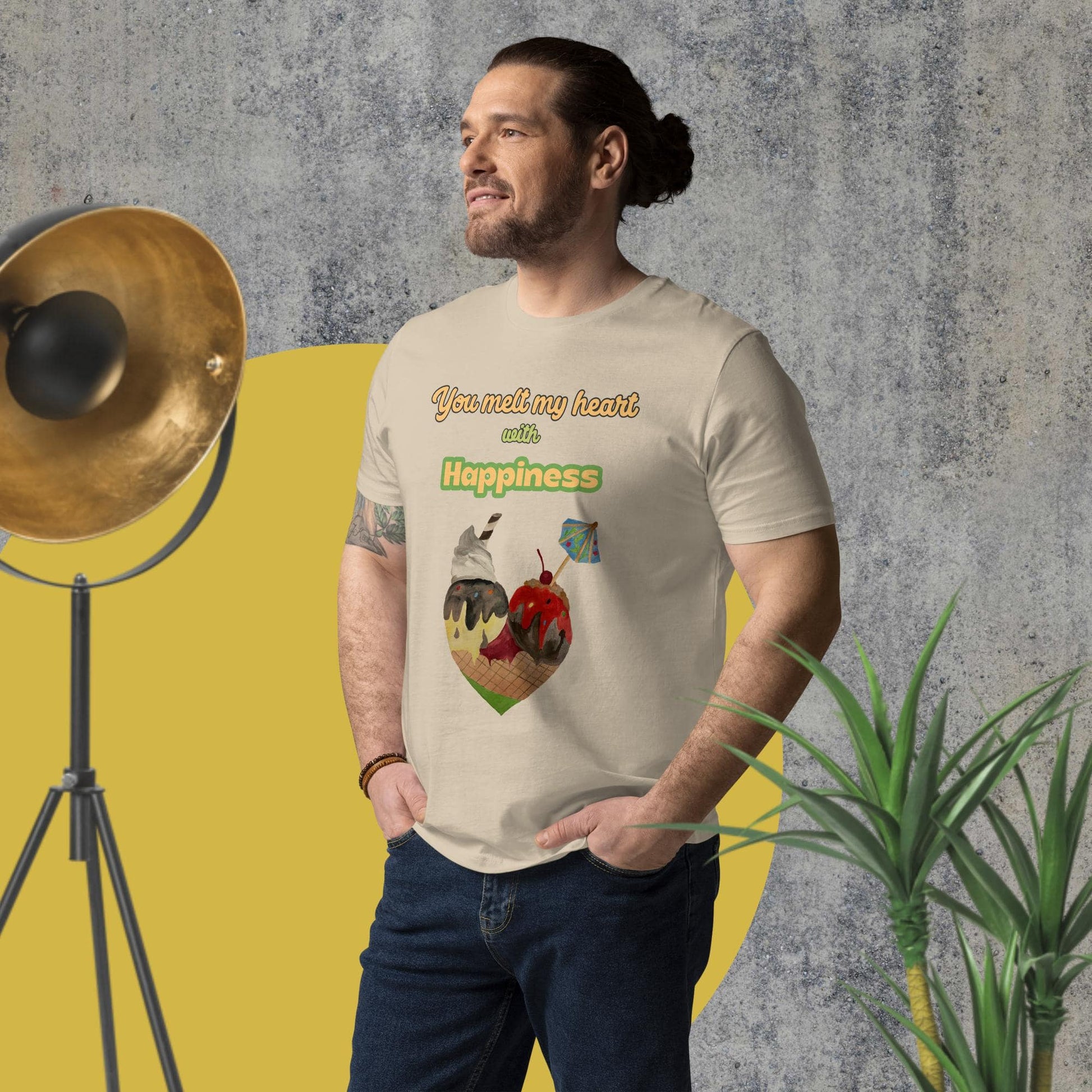Side-angled view of man wearing desert dust organic cotton t-shirt with illustrated ice cream cone heart and uplifting quote, showcasing fit and print placement.