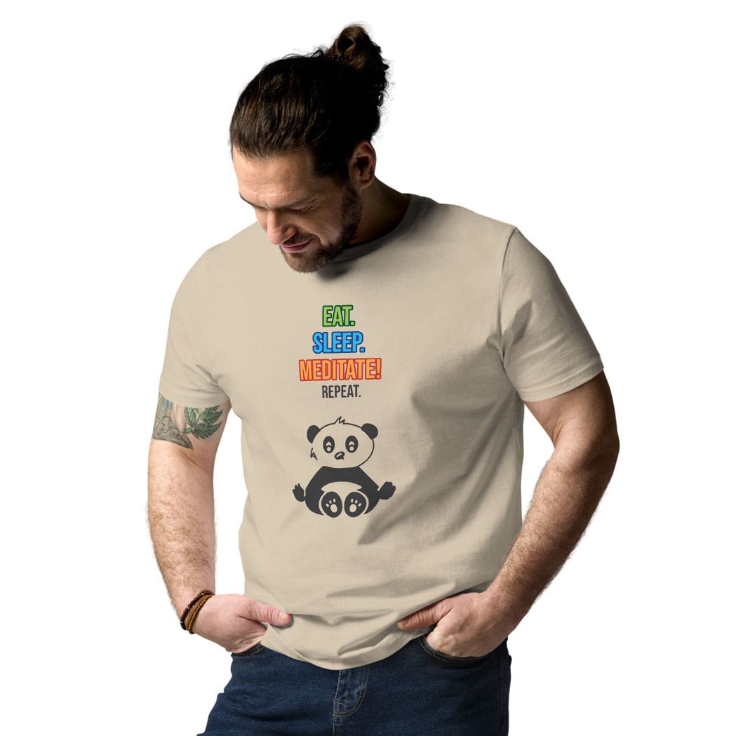 Man wearing a desert dust t-shirt with colorful "Eat. Sleep. Meditate! Repeat." panda design, front view at slight angle, tucked into jeans.