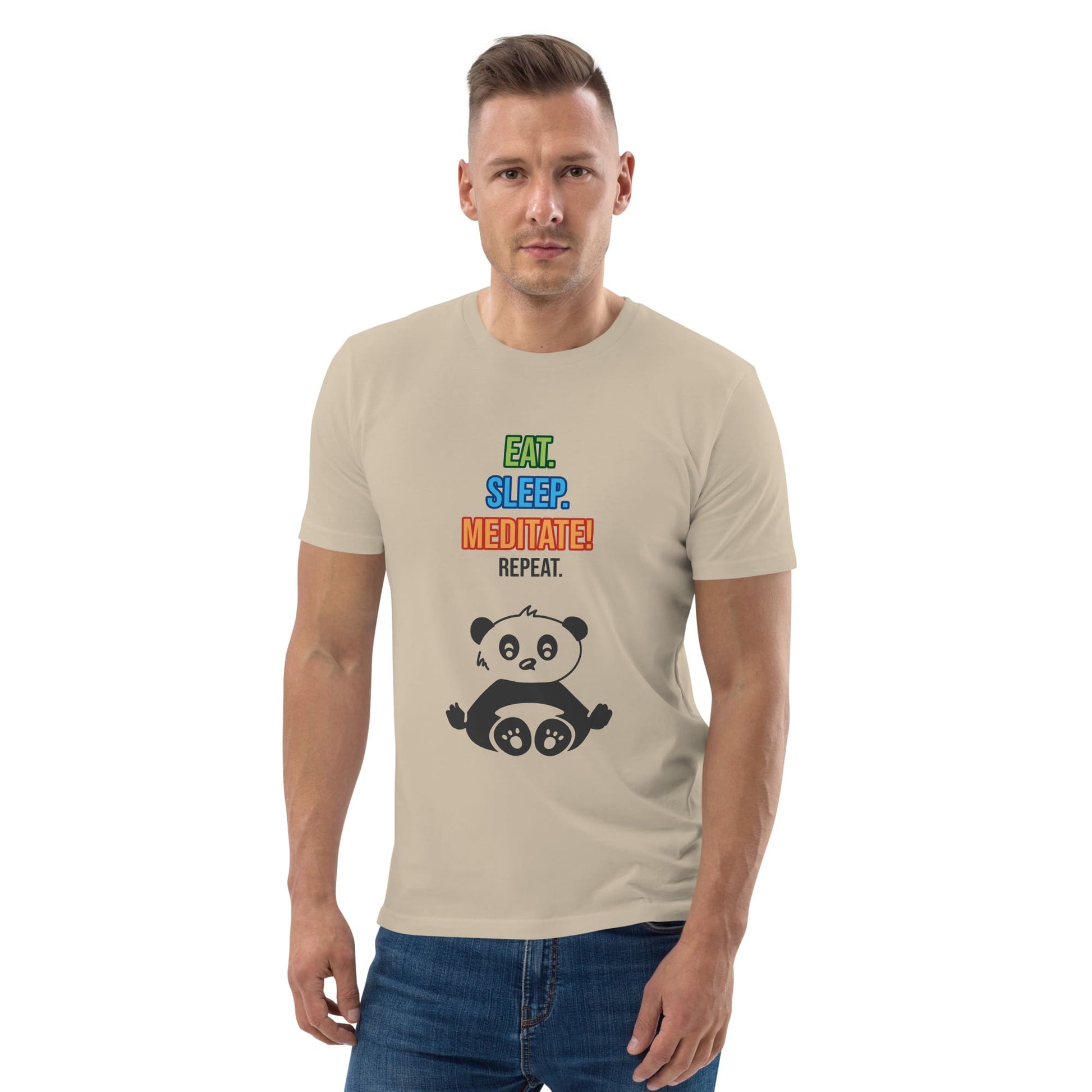 A man wearing a beige organic cotton t-shirt with colorful text that reads “EAT. SLEEP. MEDITATE! REPEAT.” above a cartoon panda sitting in a lotus position. 