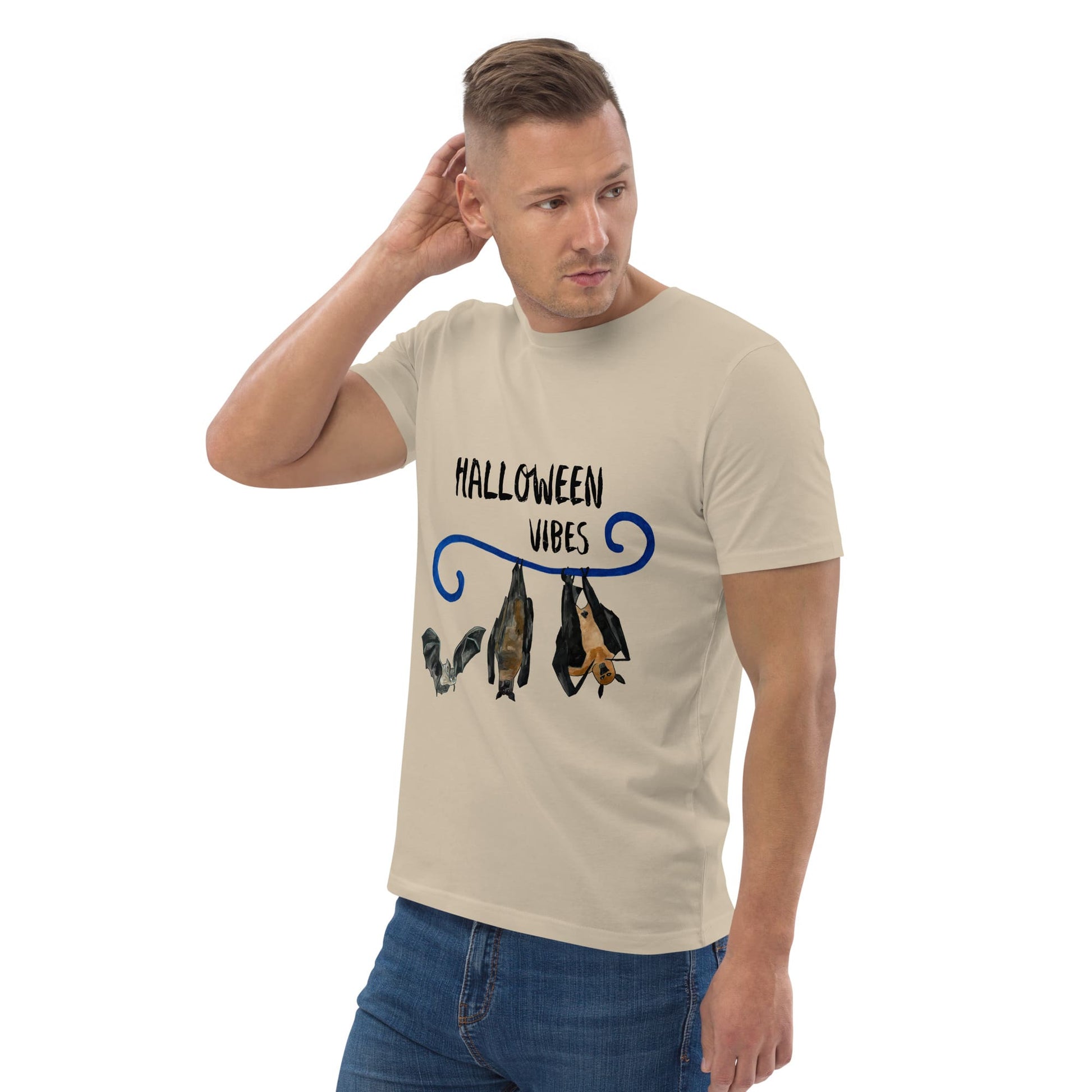Man wearing a beige t-shirt with 'Halloween Vibes' text and bat graphics on a white background