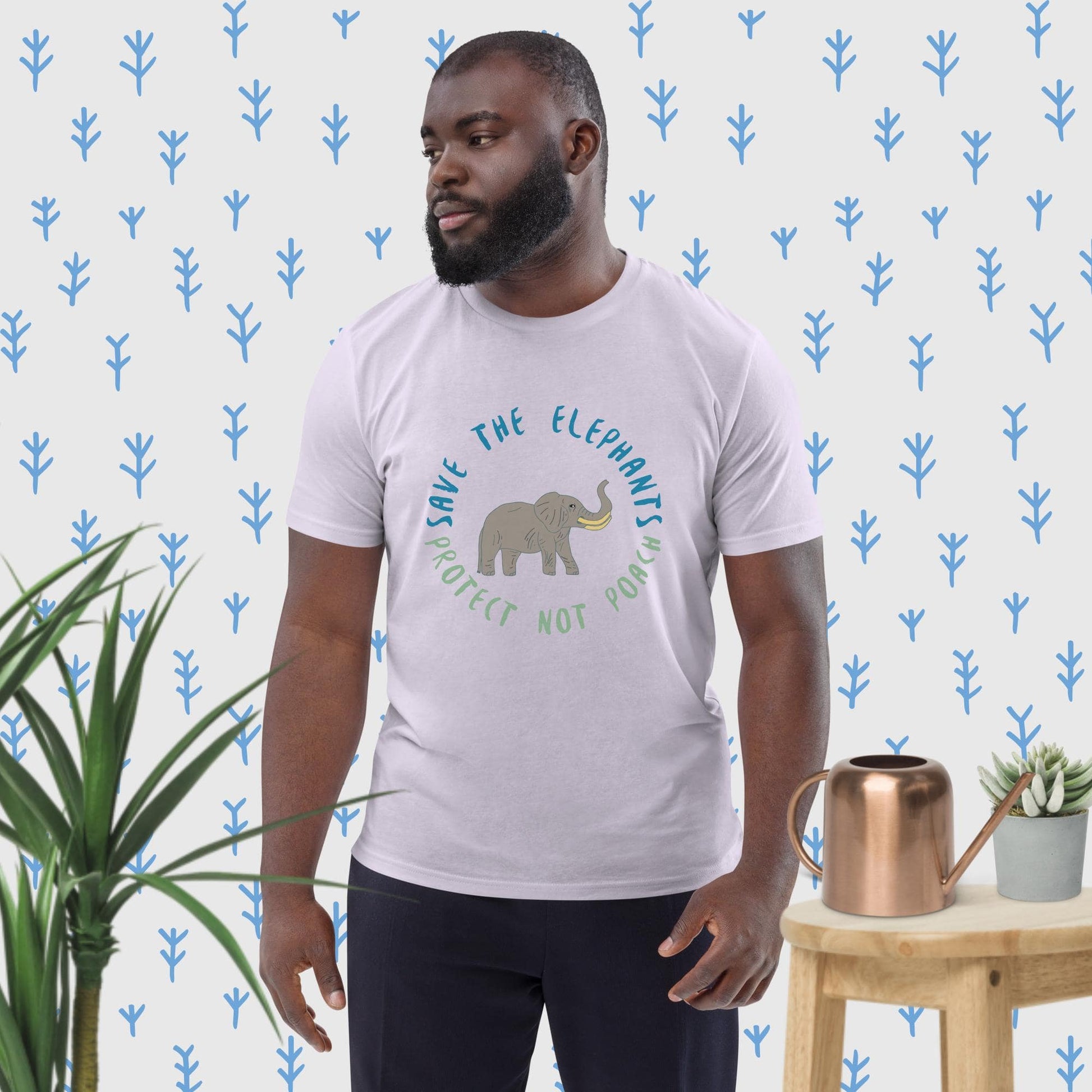 Man wearing a lavender organic cotton t-shirt with a hand-illustrated elephant and “Save the Elephants – Protect Not Poach” message; front view, right angle.