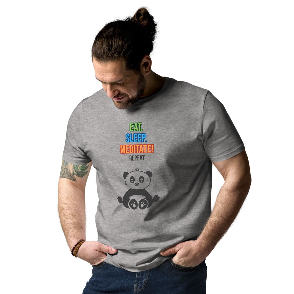 Man wearing heather grey t-shirt with “Eat. Sleep. Meditate! Repeat.” panda design, front view at slight angle, shirt tucked into jeans.