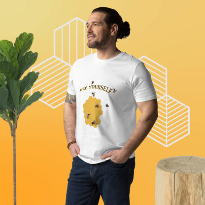 Man wearing a white t-shirt with a bee-themed design  of a beecomb and the words 'Bee Yourself' on a yellow background