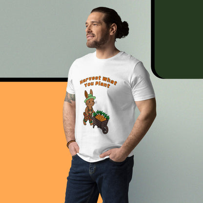 Man wearing a white t-shirt with a graphic of a rabbit and text 'Harvest What You Plant' , standing against a gradient background.