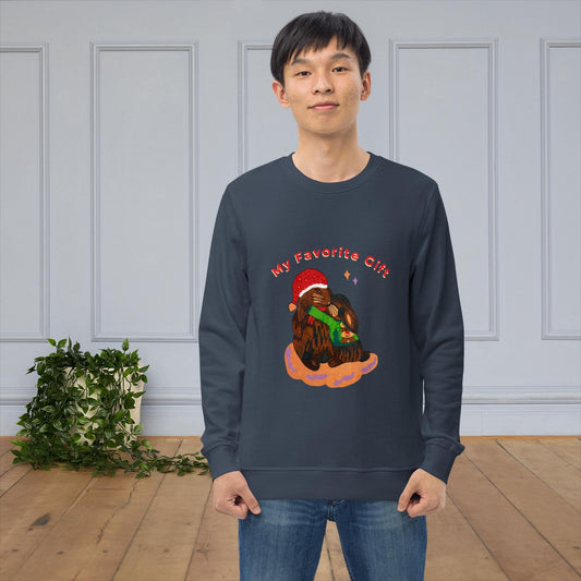 Man wearing a navy blue sweatshirt with a bunny christmas design in a room with a light gray wall and wooden floor.