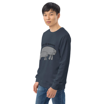 A partial front-left view of the navy sweatshirt, showing the manatee design and the Anke Wonder label on the hem.