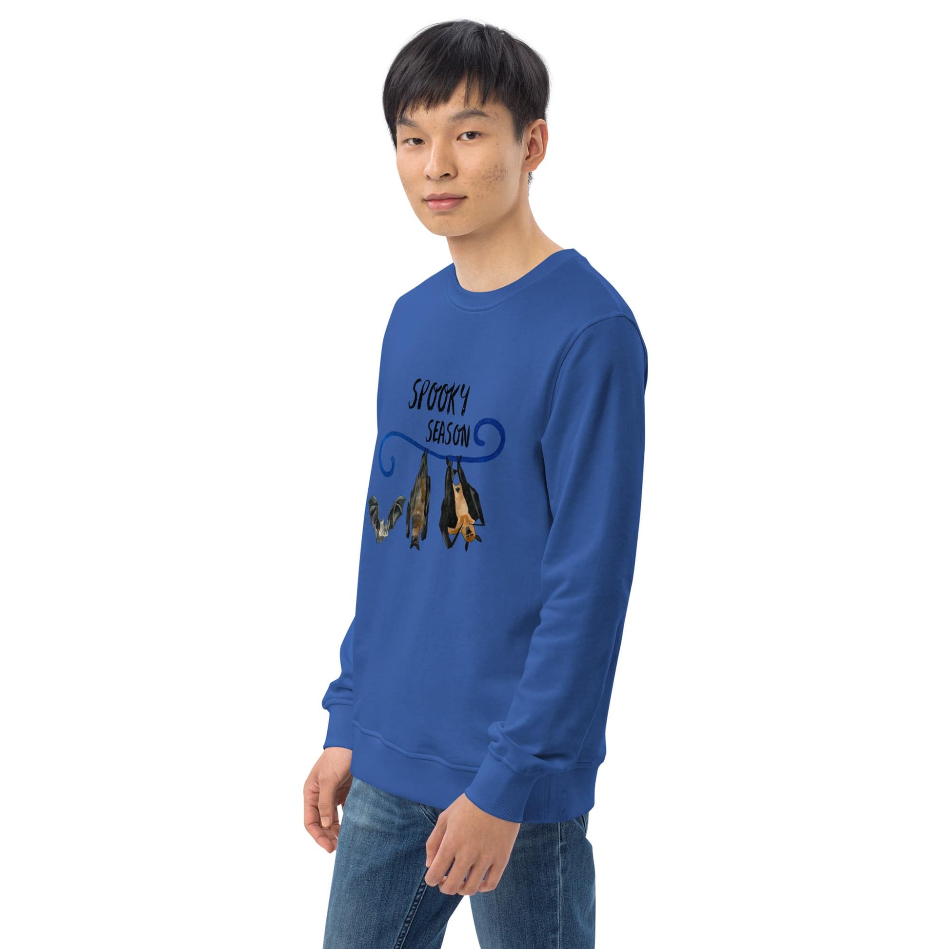 Man wearing a blue sweatshirt with graphic design of bats on a white background