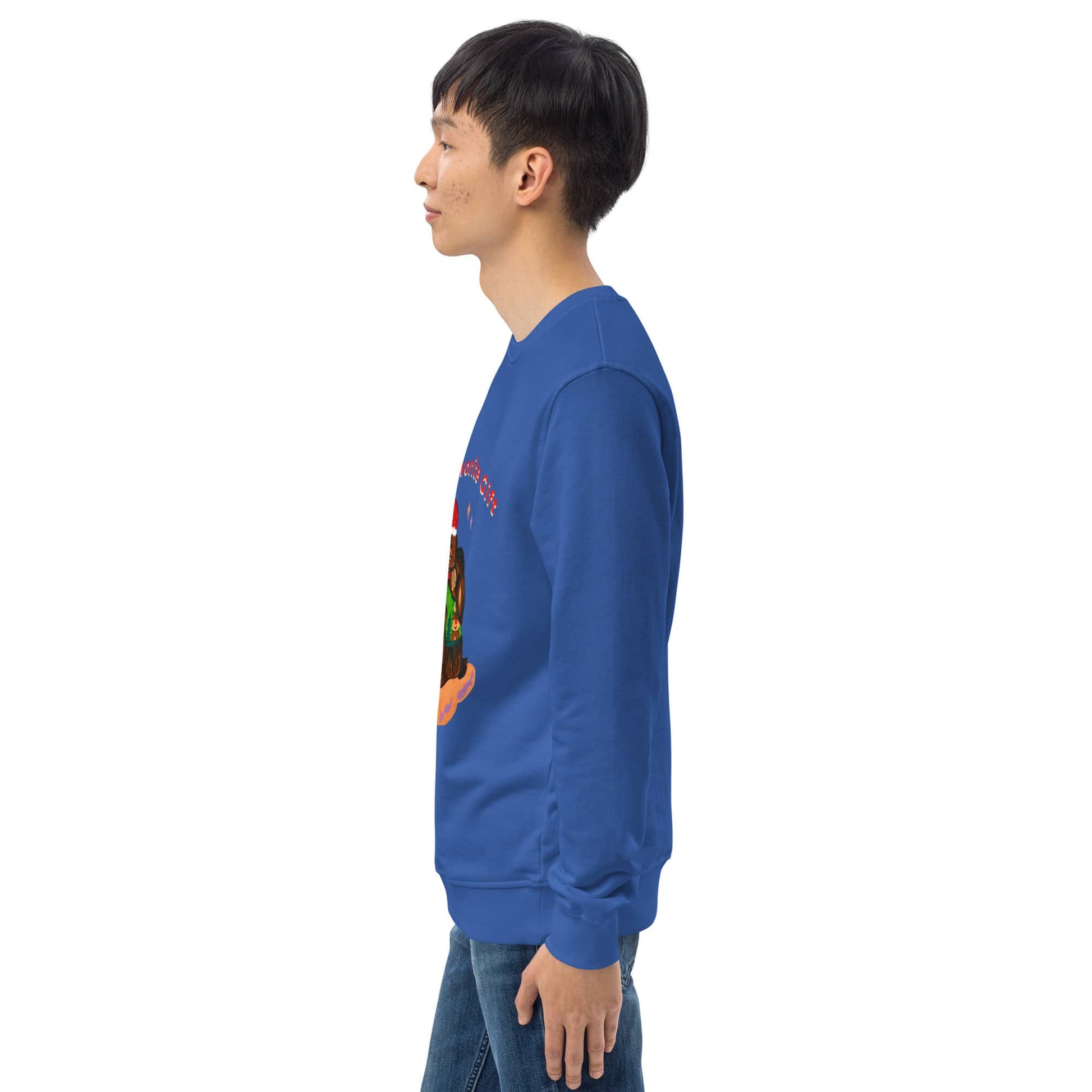 Side of man wearing a blue sweatshirt with a colorful christmas graphic on the back, standing against a white background