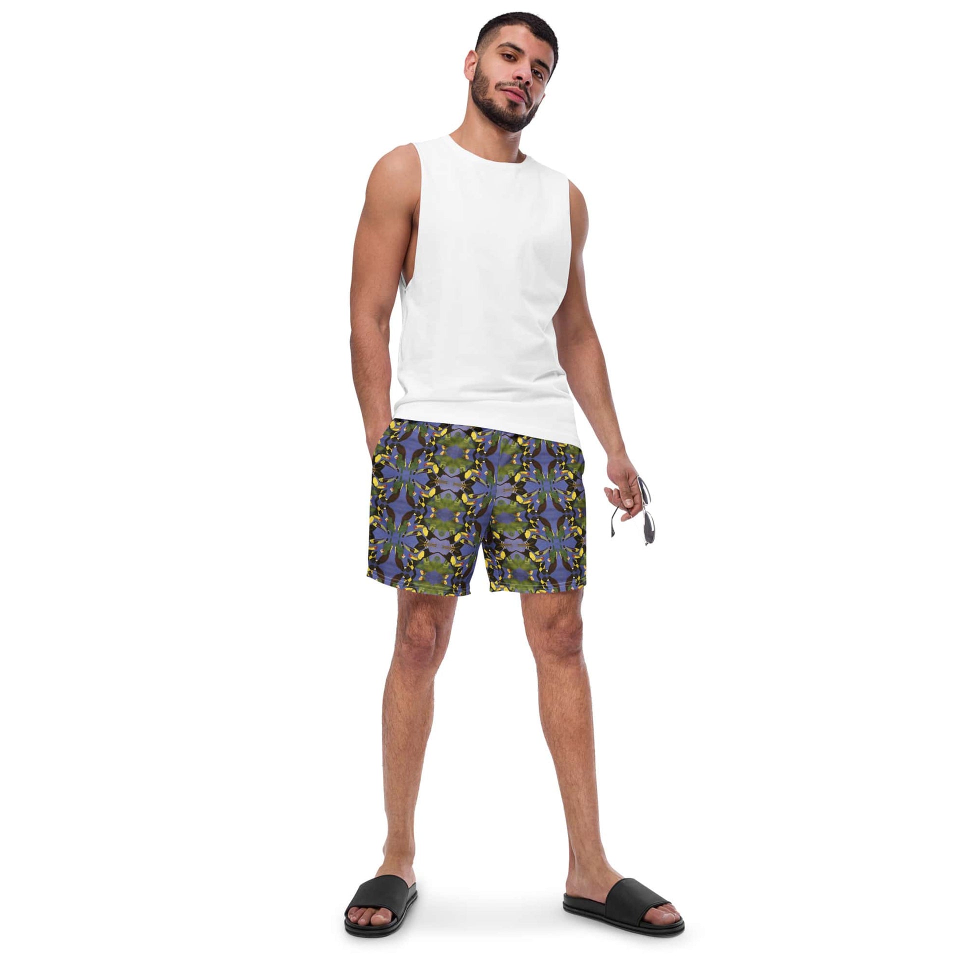 Man wearing tropical bird swim trunks by Anke Wonder and a white shirt for a relaxed look.