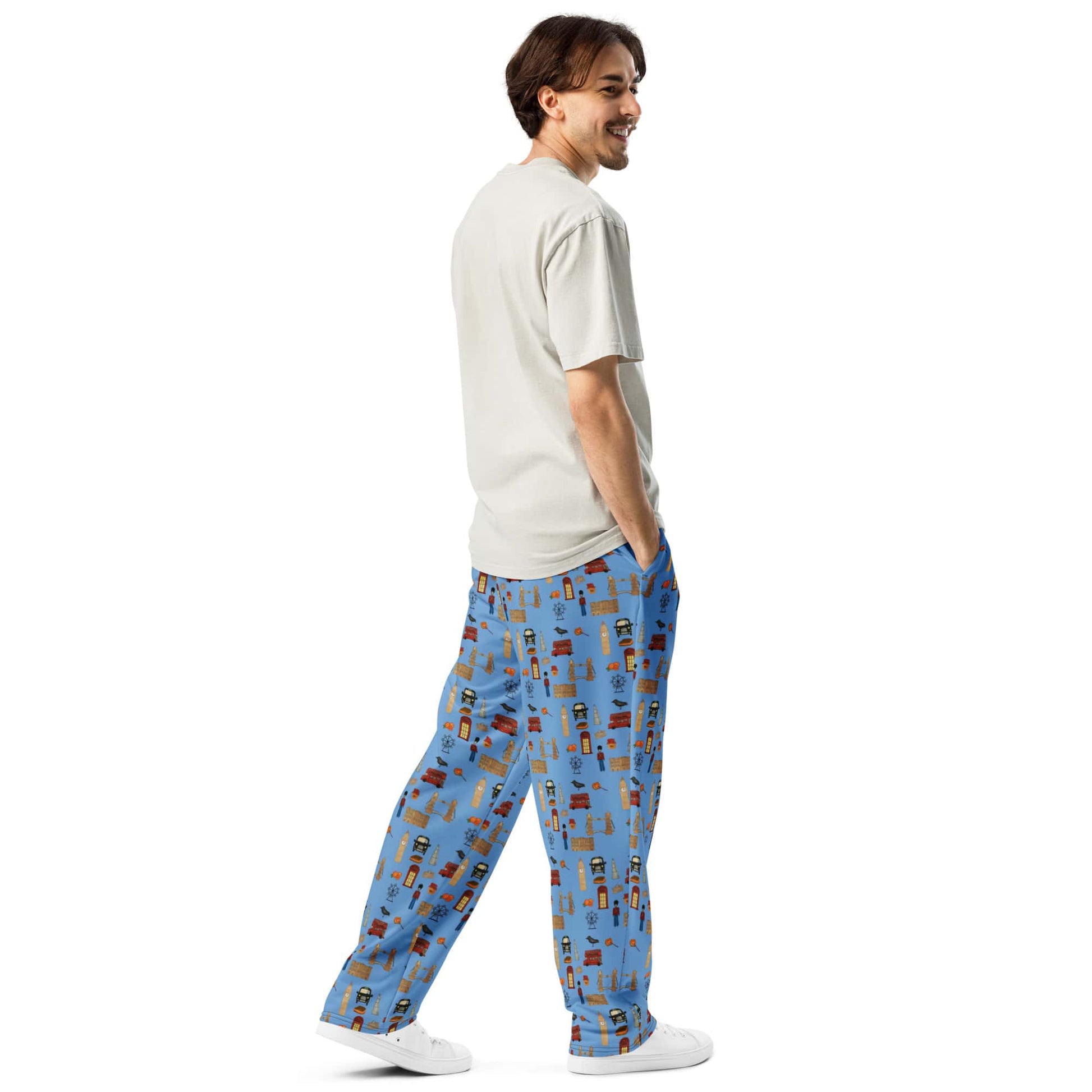 Back-right view of men’s blue joggers featuring handpainted UK-inspired artwork on recycled fabric.