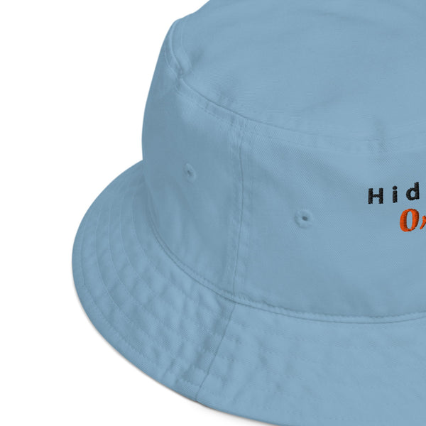 Side view close-up of the blue embroidered bucket hat, showcasing fine stitching and quality fabric with a slight curve in the brim.