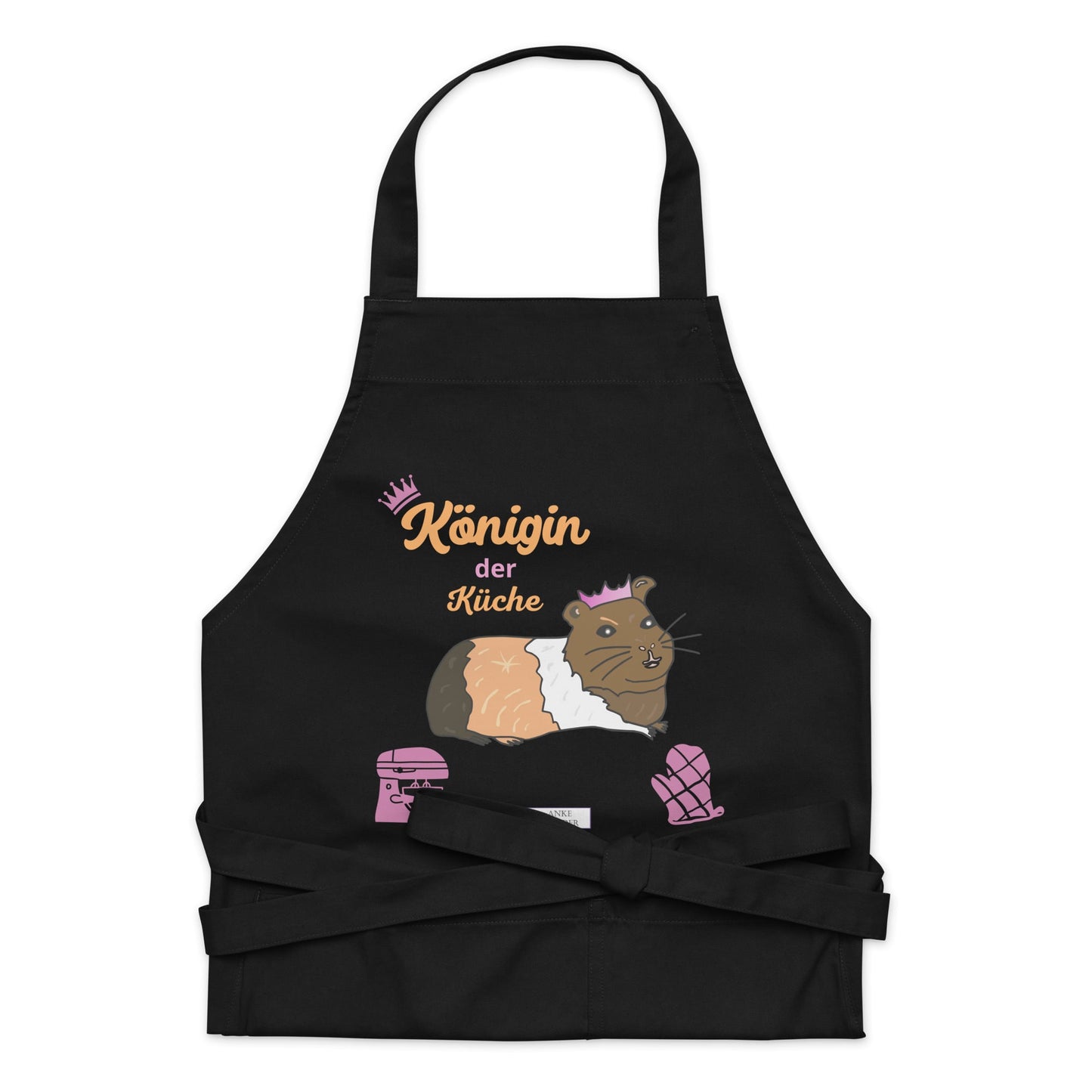 A flat-lay image of the black apron highlighting the detailed guinea pig illustration and the “Königin der Küche” lettering.
