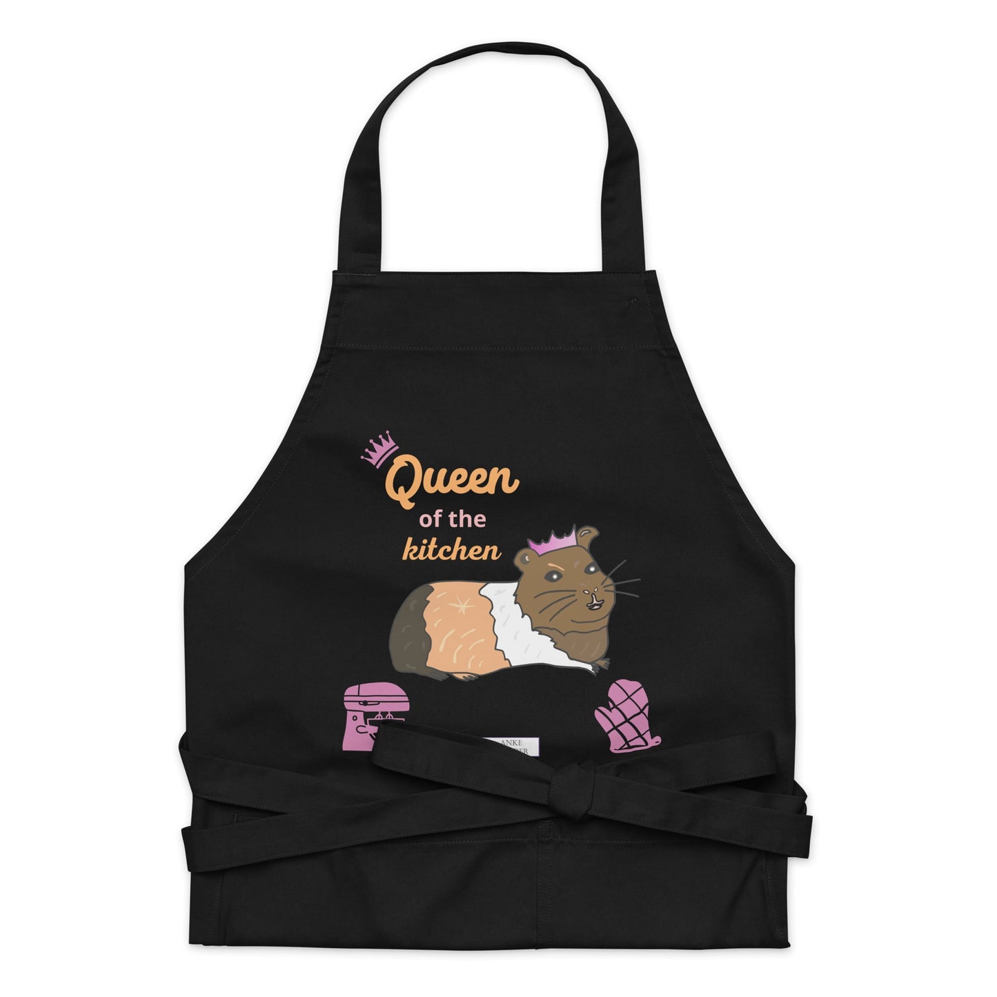 A flat-lay of the black apron detailing the guinea pig illustration and “Queen of the Kitchen” lettering in playful pink.