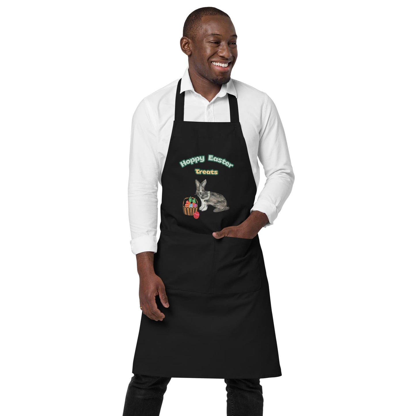 Man wearing black organic cotton "Hoppy Easter Treats" apron with large front pocket.