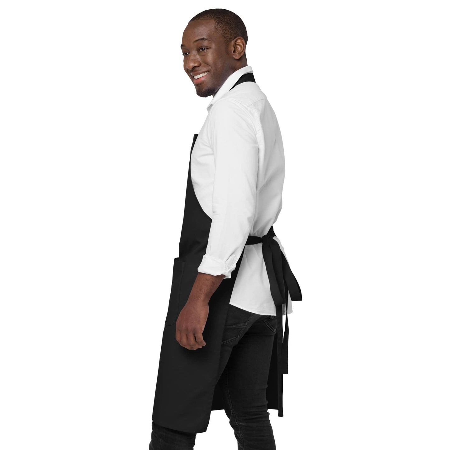 Side view of man wearing black "Hoppy Easter Treats" apron, showing adjustable straps in the back.