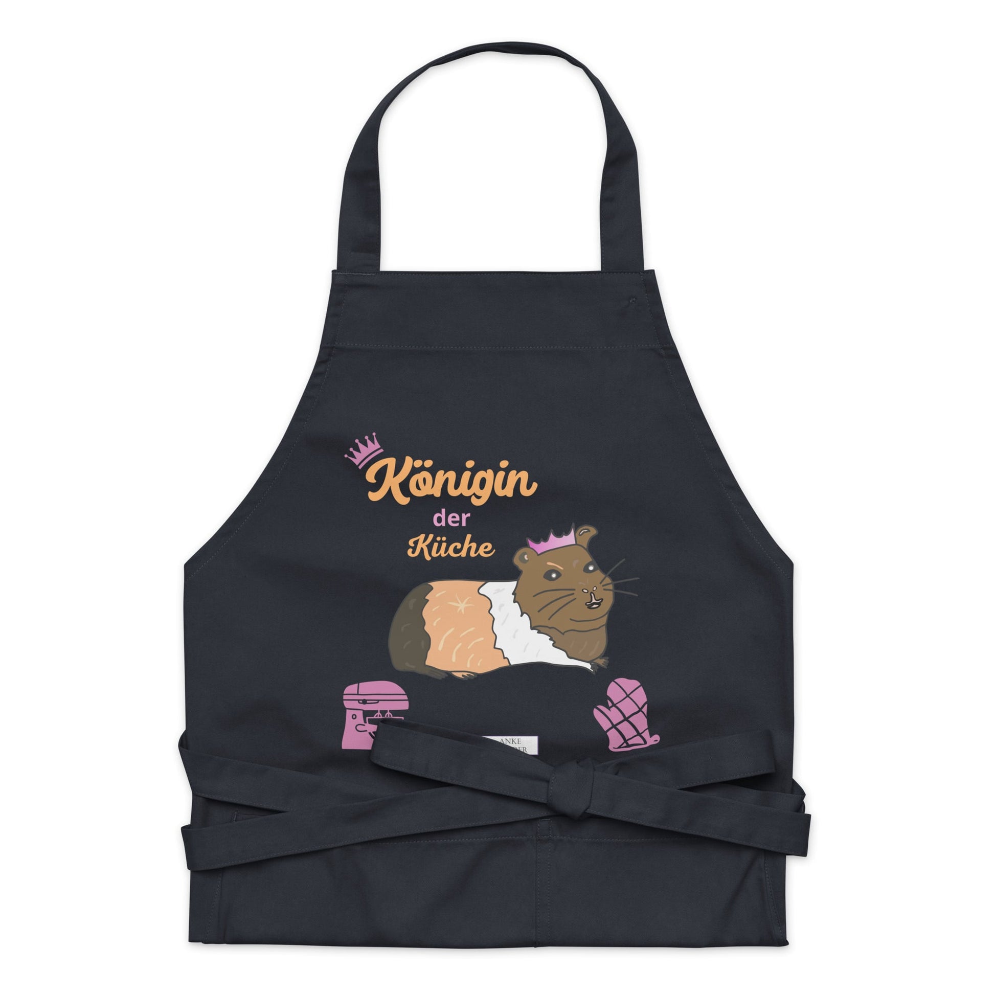 A flat-lay of the navy apron showing the detailed guinea pig design and the clear, stylish “Königin der Küche” lettering.
