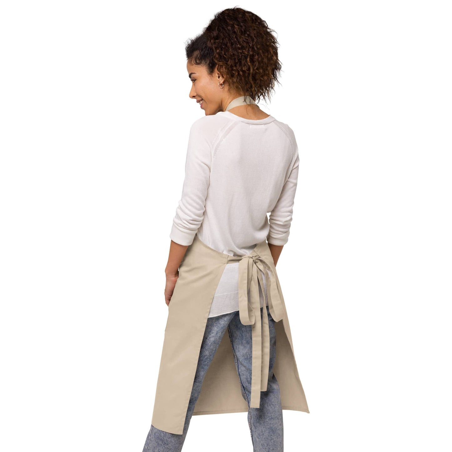 The back view of the natural apron, showing adjustable straps and a tied waist, ideal for comfortable cooking, designed by Anke Wonder.