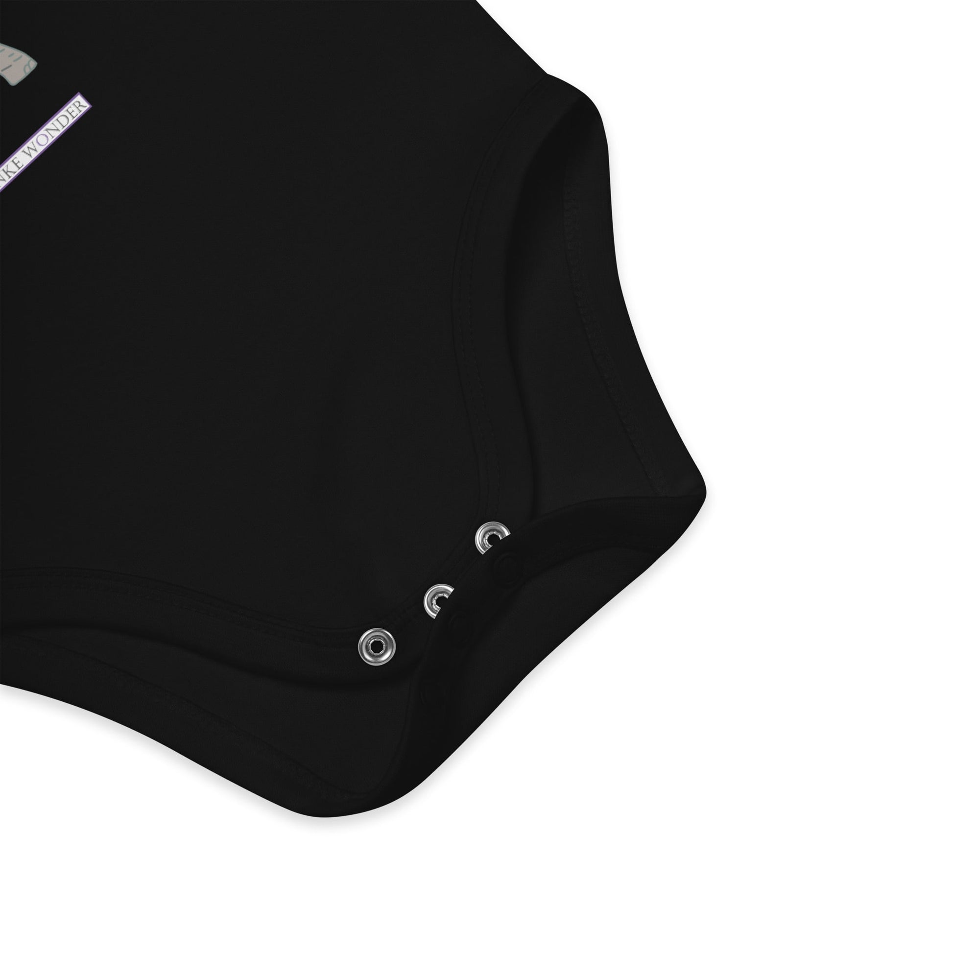 Nickel-free snap closure detail at the bottom of black baby onesie with Anke Wonder logo.