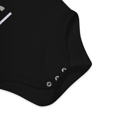 Nickel-free snap closure detail at the bottom of black baby onesie with Anke Wonder logo.