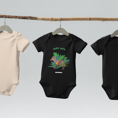 Three baby onesies on hangers with a black baby onesie that has a colorful zebra design on a white background