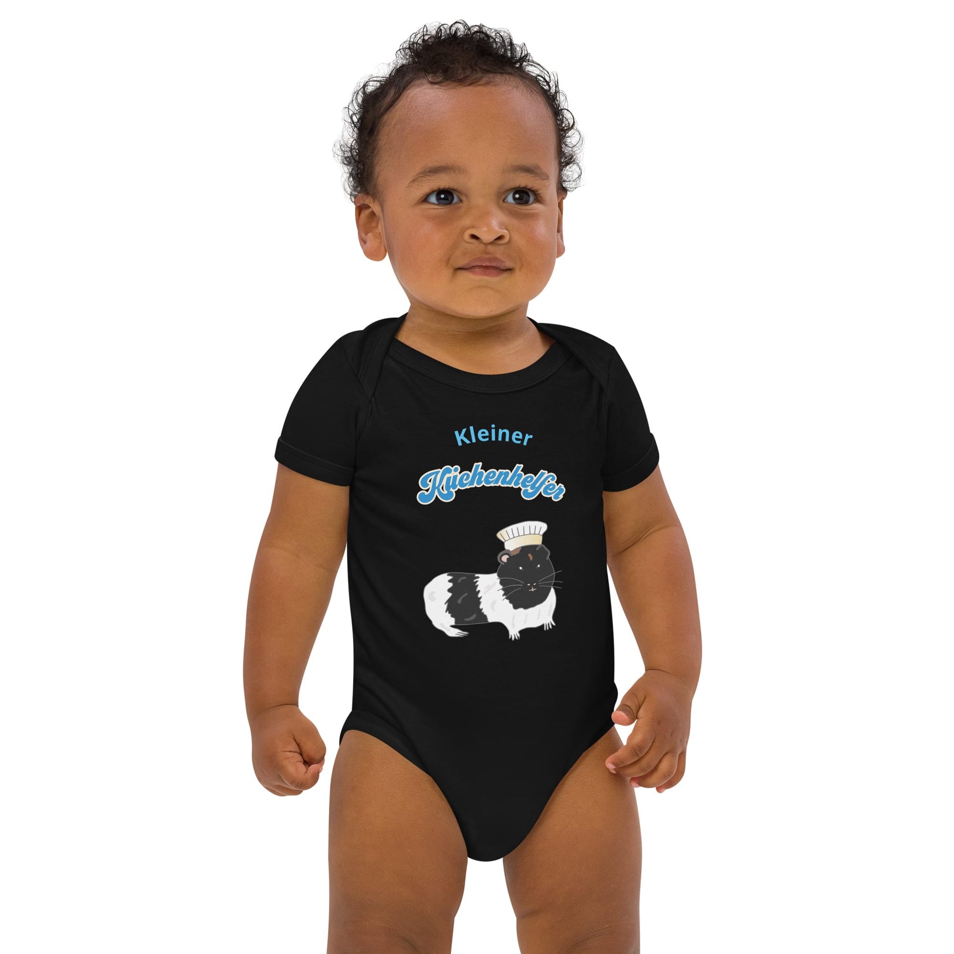 Organic baby boy bodysuit in black with a guinea pig chef illustration and "Kleiner Küchenhelfer" text.