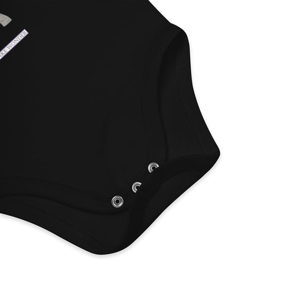 Three nickel-free snaps at the bottom of black baby bodysuit for convenience by Anke Wonder.