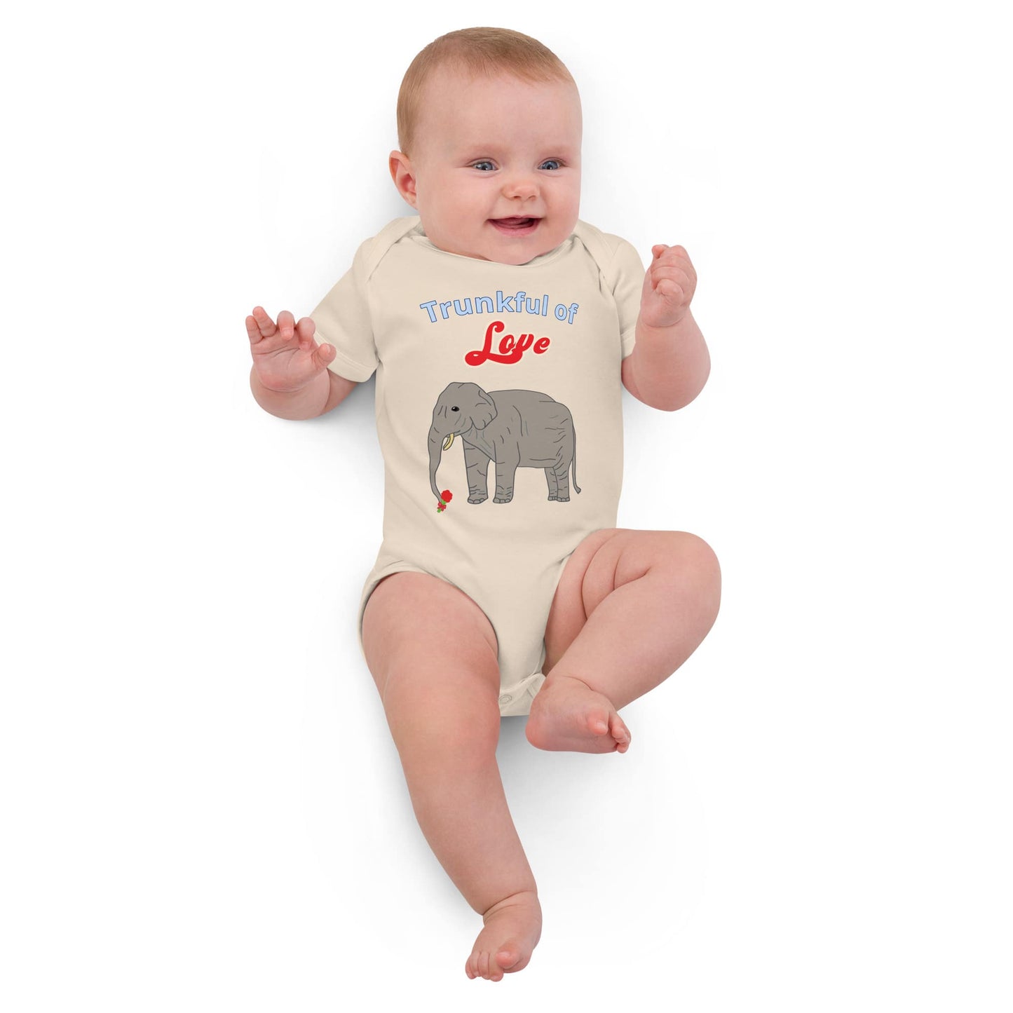 Smiling baby in a natural cotton bodysuit with an elephant holding a flower.