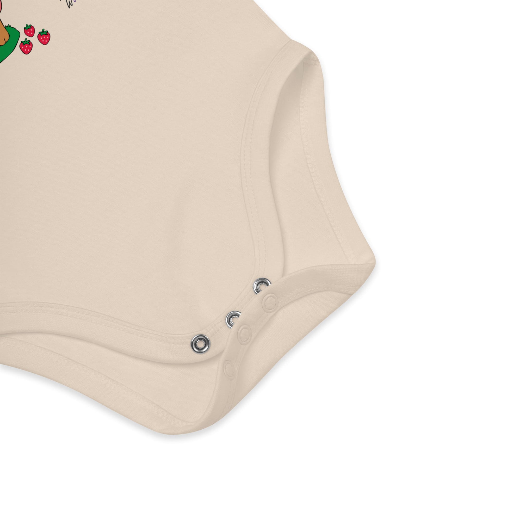 Close-up of a beige baby romper with button details on a white background