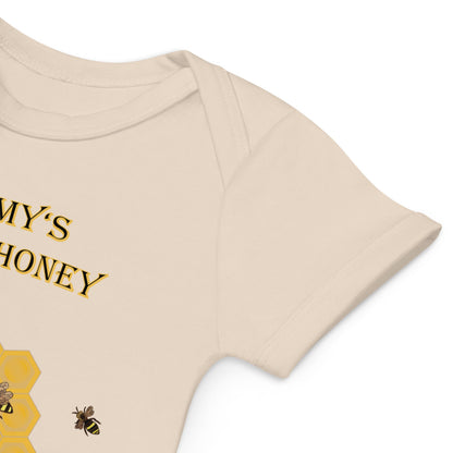 Close-up of the envelope neckline on a natural organic cotton baby bodysuit, designed for easy dressing.