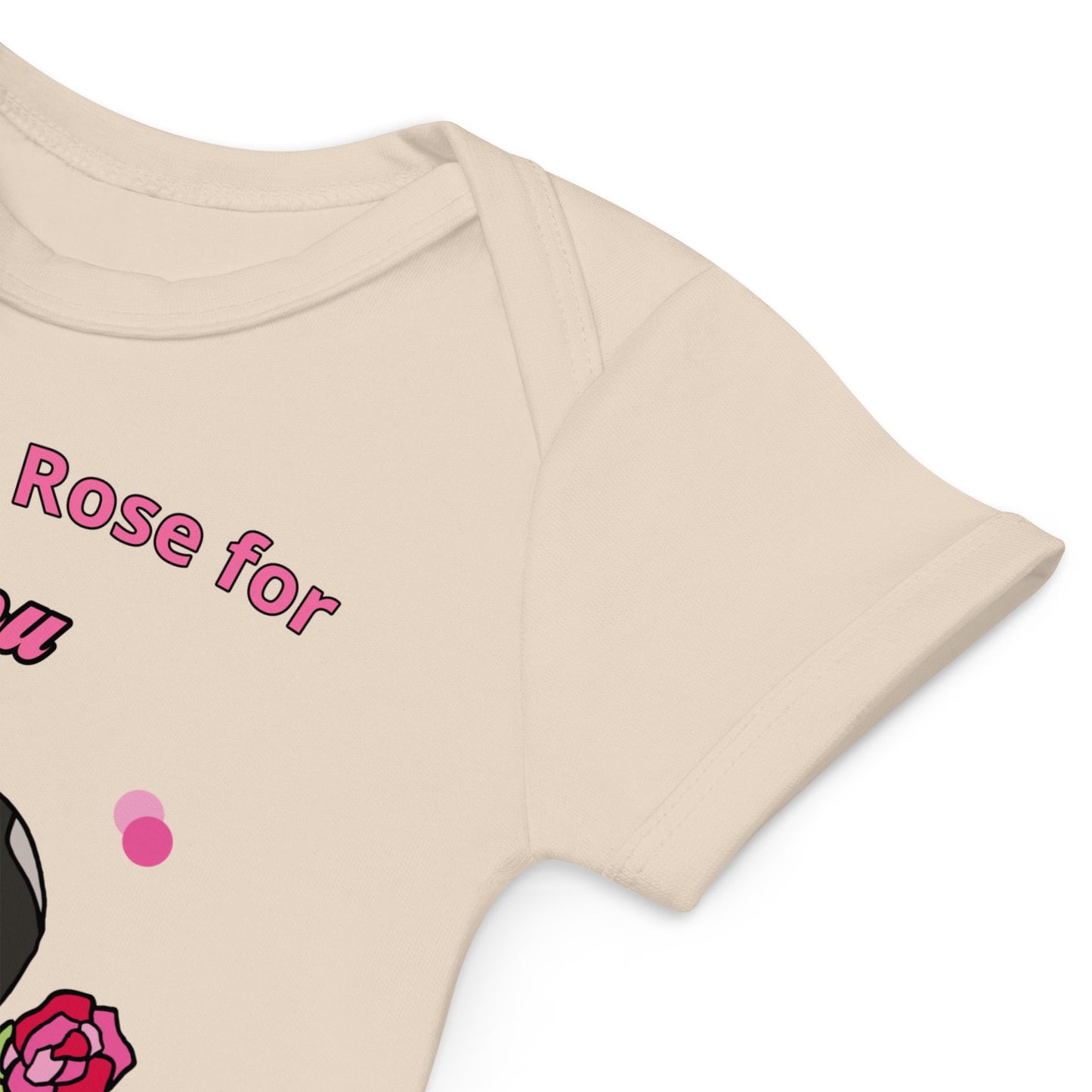 Envelope-style neckline designed for easy dressing and undressing of natural colored organic cotton baby bodysuit with bunny holding a pink rose.