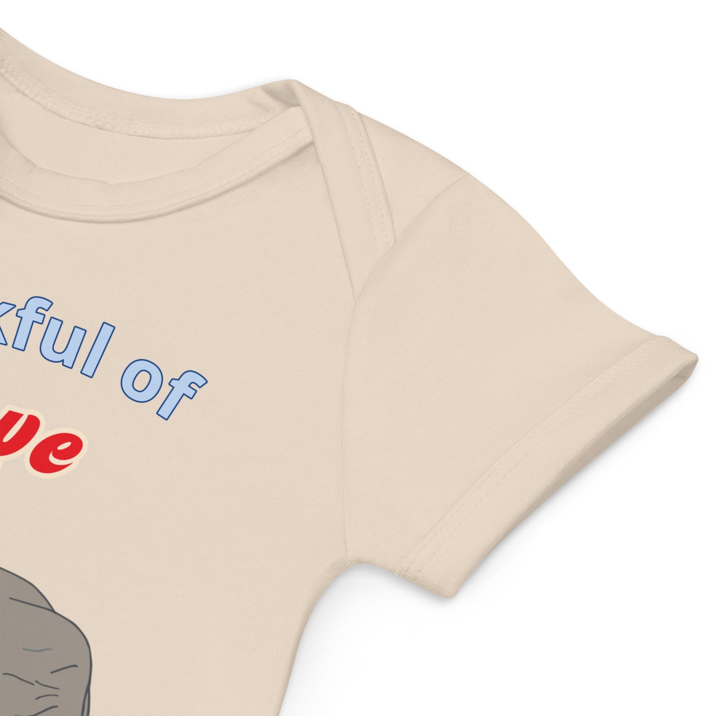 High-quality stitching on organic cotton natural color baby bodysuit sleeves with elephant design by Anke Wonder.