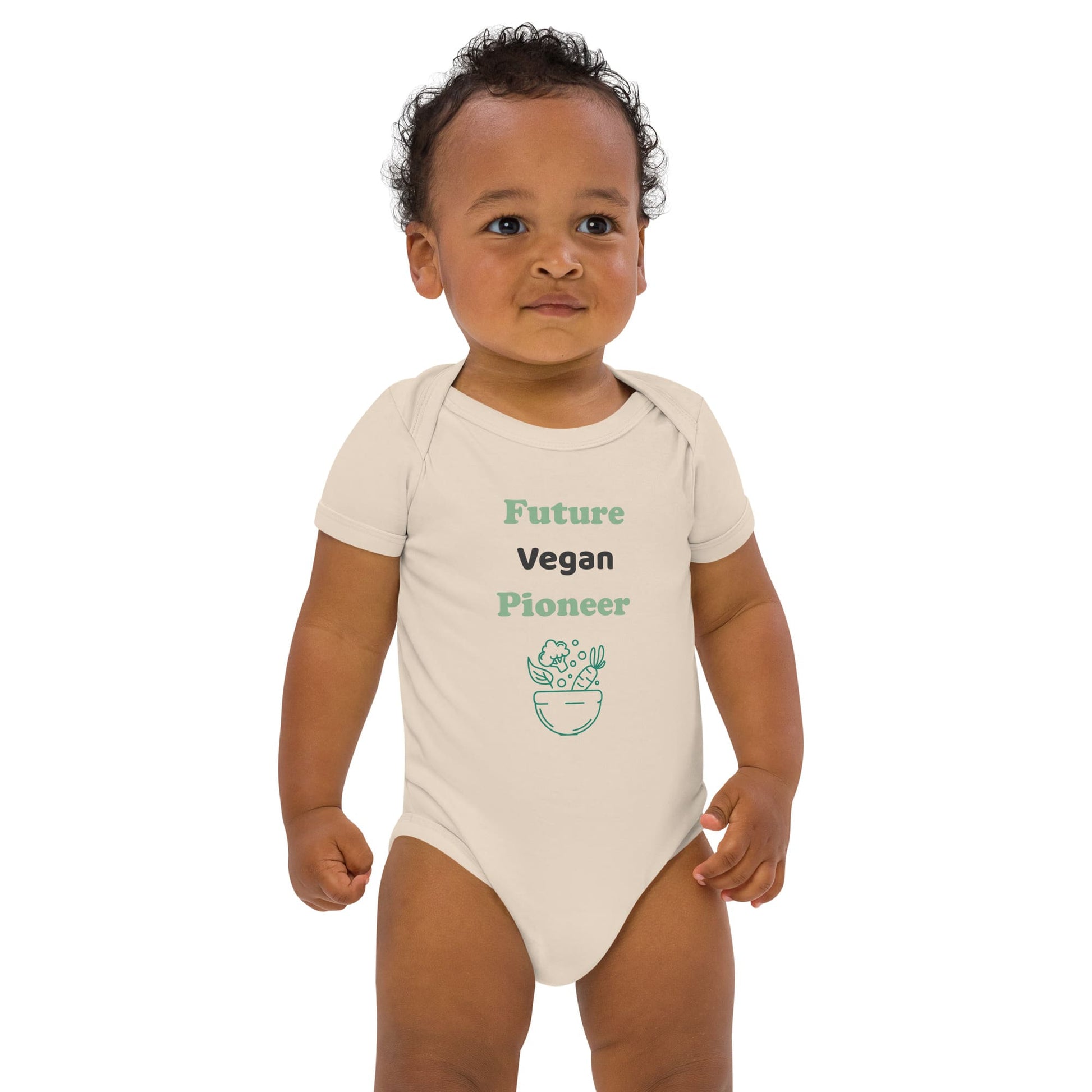 A baby wearing an organic natural-colored bodysuit with the words “Future Vegan Pioneer” in green and black text, featuring a bowl of plant-based food illustration.