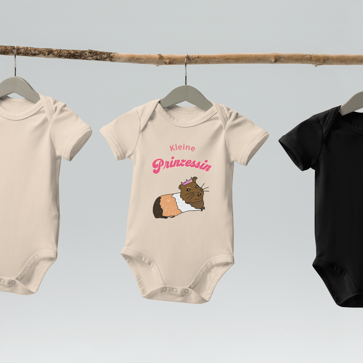 Eco-friendly baby bodysuit in organic natural color, with a guinea pig illustration and pink "Kleine Prinzessin" lettering.