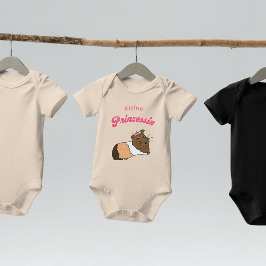 Eco-friendly baby bodysuit in organic natural color, with a guinea pig illustration and pink "Kleine Prinzessin" lettering.